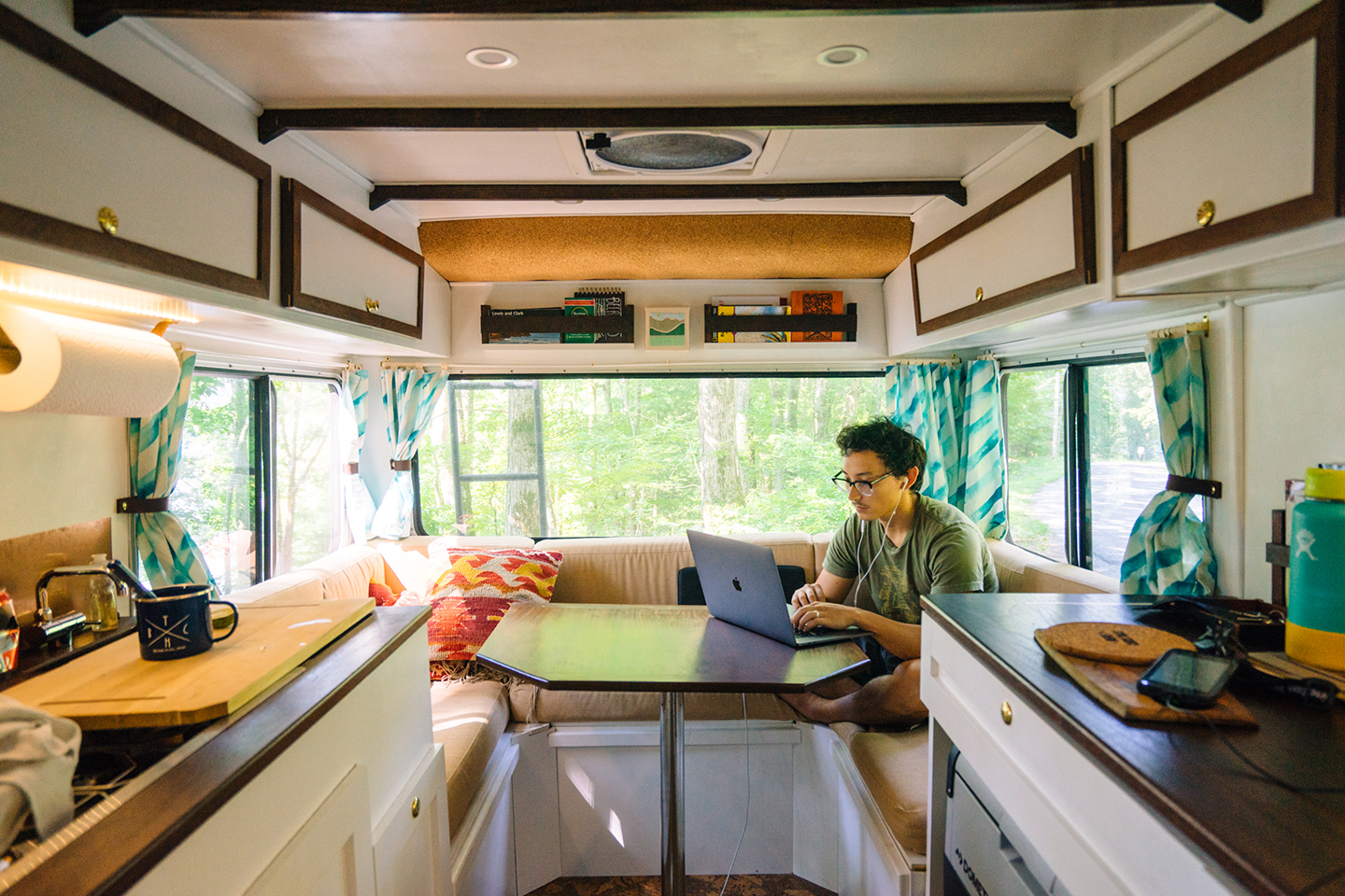 A solopreneur works from the back of an RV, running his business remotely